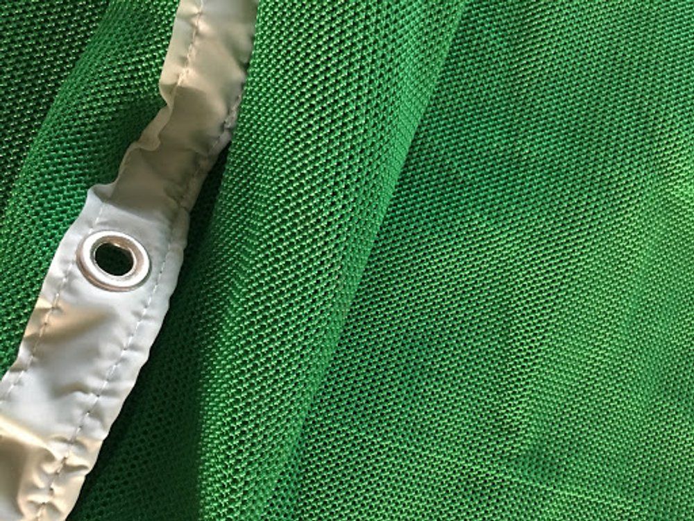 Close-up of archery backstop net edge stitching and brass grommet
