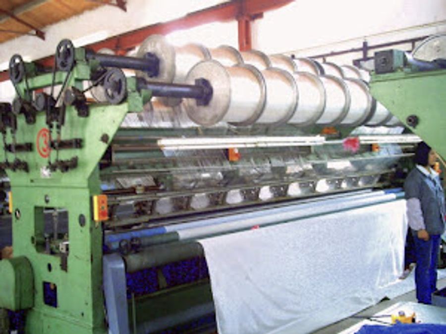 Archery netting being woven on a Raschel warp knitting loom