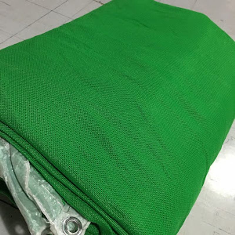 Green HDPE shade cloth rolls stacked in the warehouse